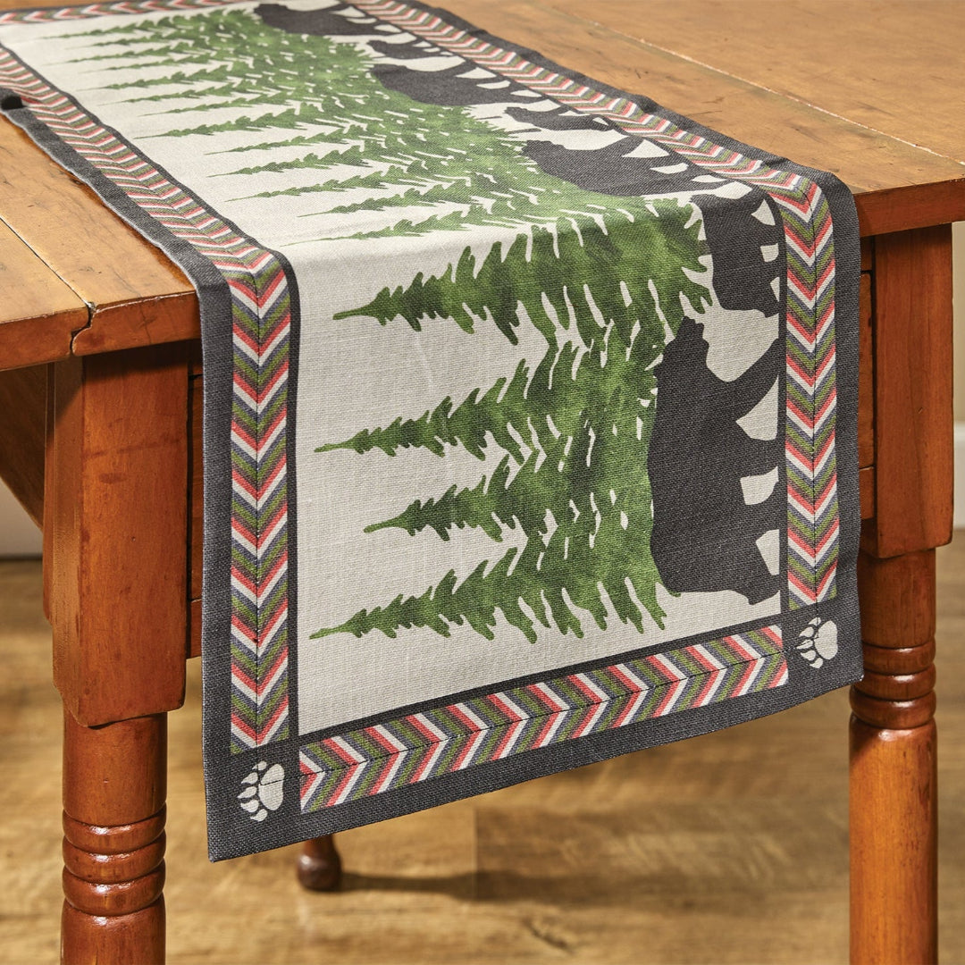 Table runner with bear and tree design on a wooden table