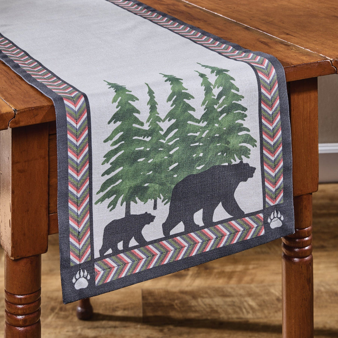 Table runner with bear and tree design on a wooden table