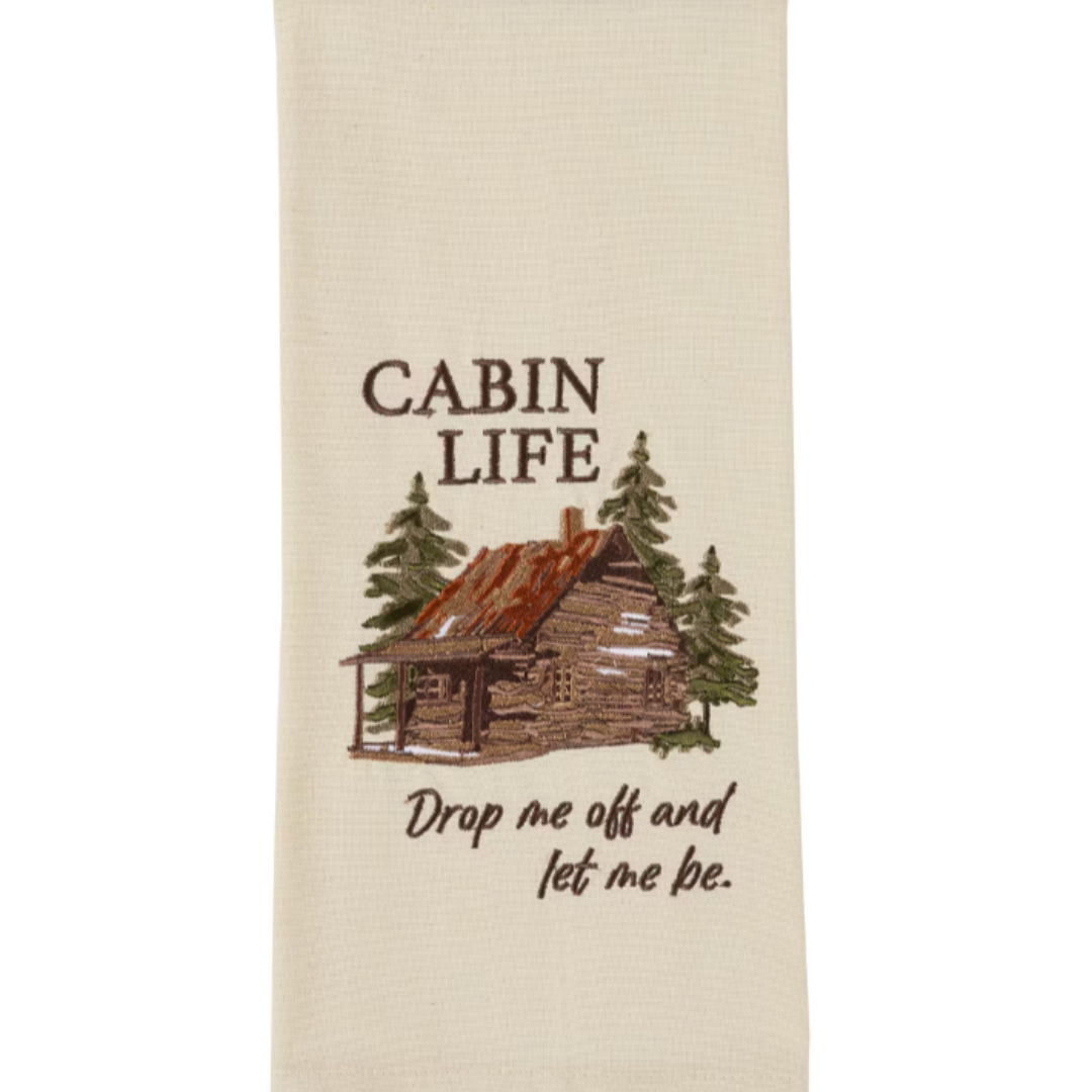 Tea towel with cabin and tree design and text 'Cabin Life Drop me off and let me be.'
