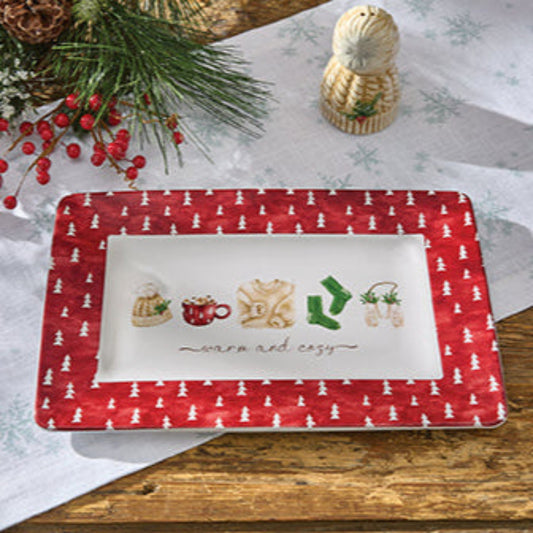 Rectangular platter with Christmas design on a wooden table with decorative elements.