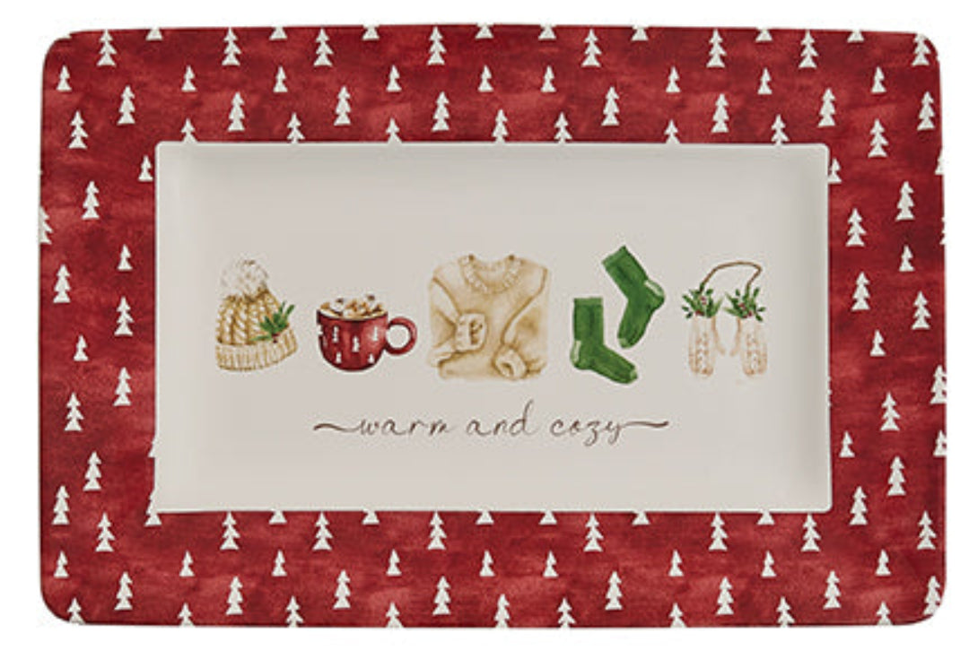 Christmas platter with winter-themed illustrations and text on a red background with white tree pattern