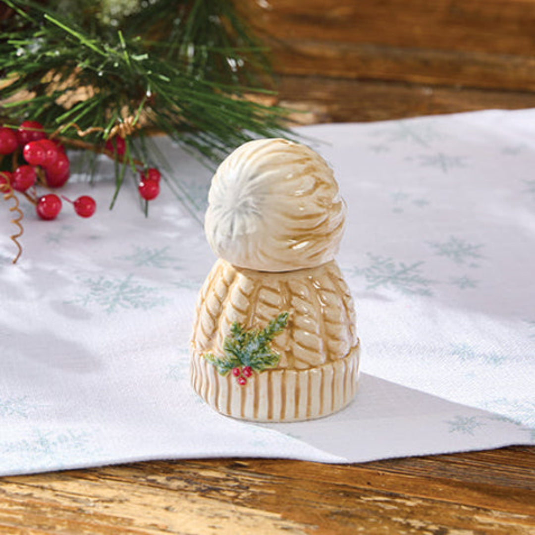 Decorative Salt & Pepper Shaker set on a wooden surface with a Christmas-themed background