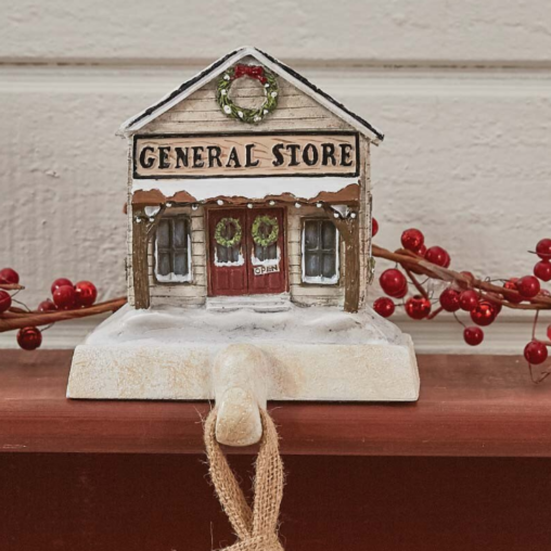 Decorative ornament of a 'General Store' with red berries on a wooden surface. Christmas Stocking Holders