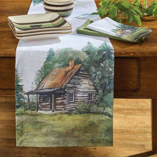Table runner with a cabin design on a wooden table
