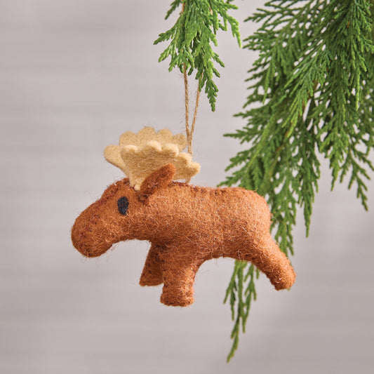 Moose-shaped wool felt ornament hanging from a branch with a plain background