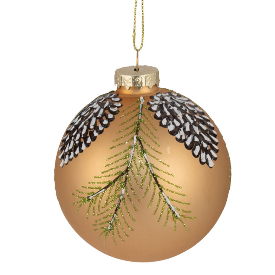 Gold Christmas ornament with greenery and pinecones on a white background