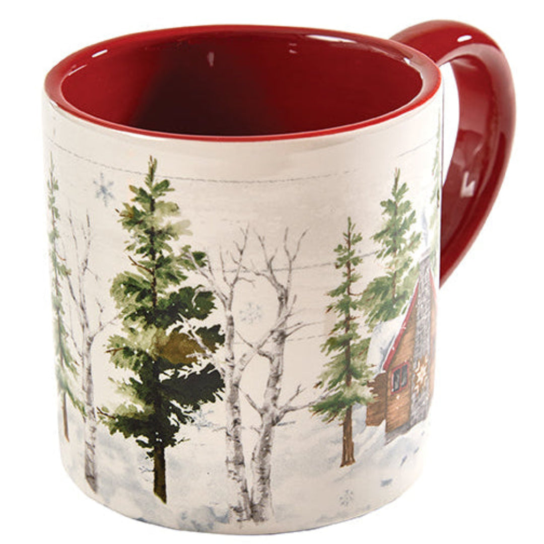 Mug with winter scene design featuring trees and a cabin, red interior and handle.