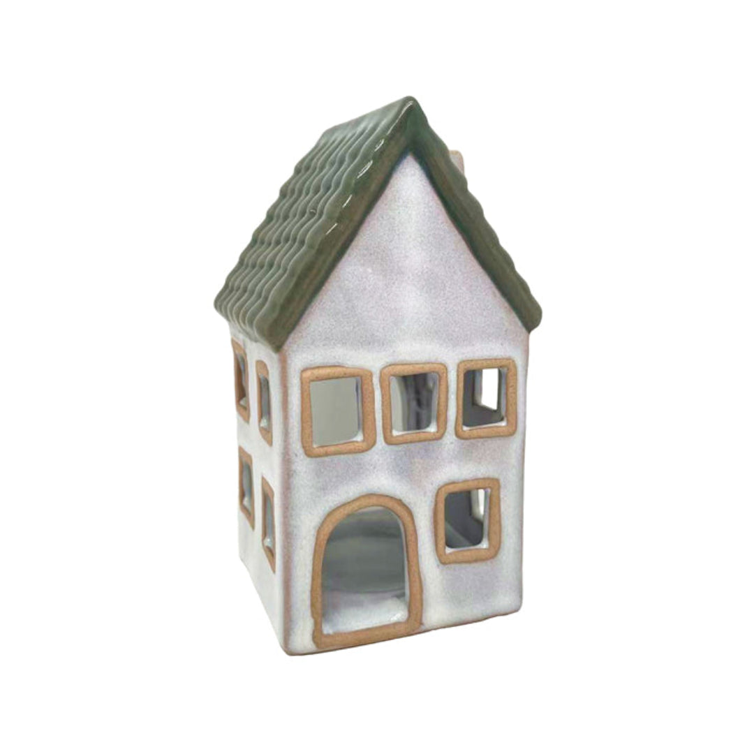Ceramic house-shaped lantern with a green roof on a white background