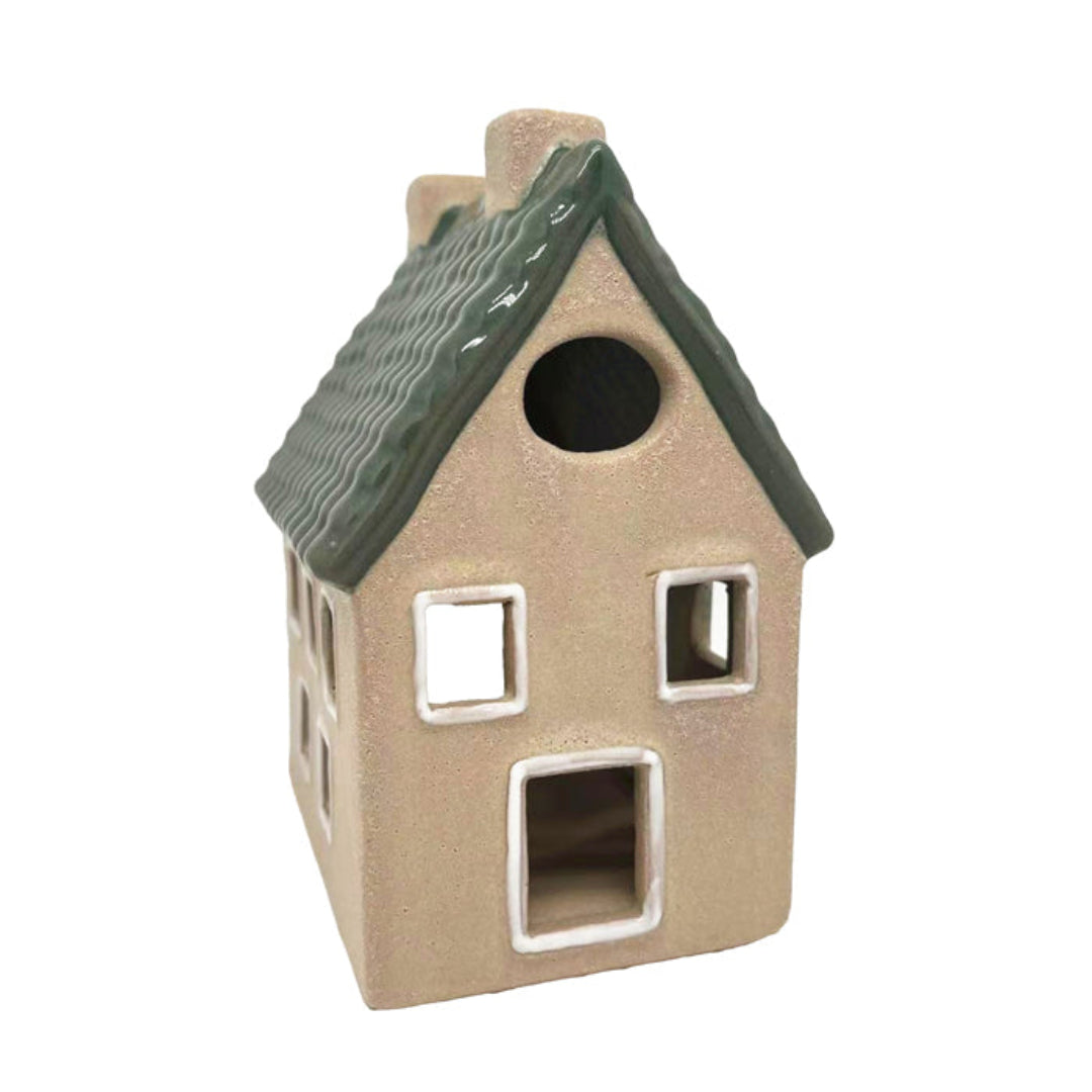 Ceramic tea light house with a green roof on a white background