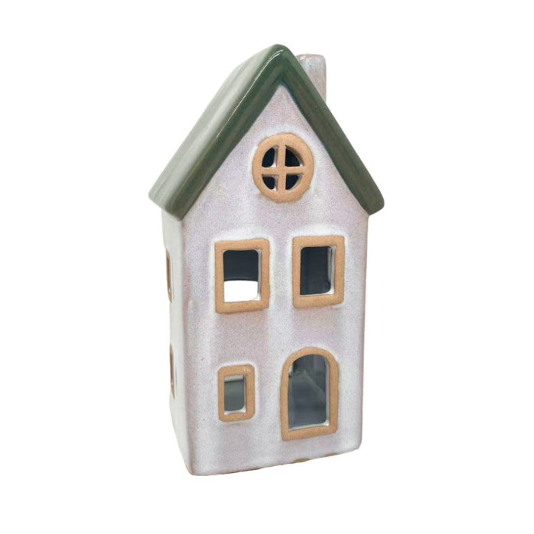 Ceramic house-shaped lantern with a green roof on a white background