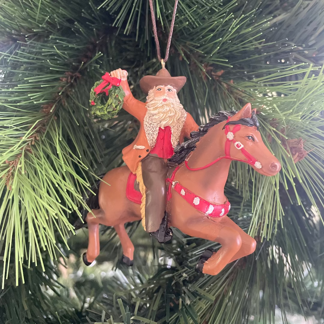 Ornament of Santa Claus riding a horse on a Christmas tree.
