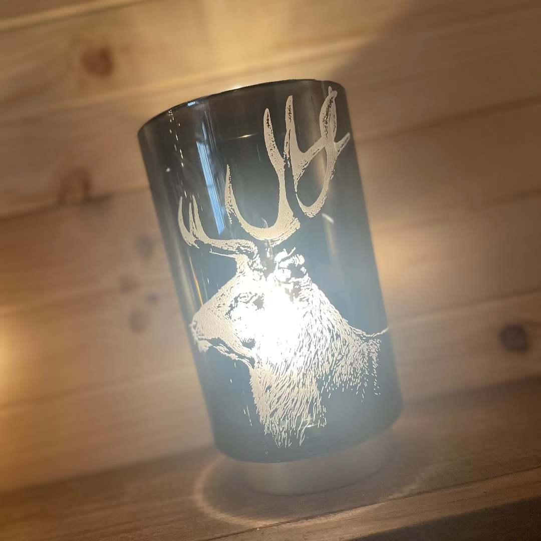 Lamp with a deer design on a wooden surface