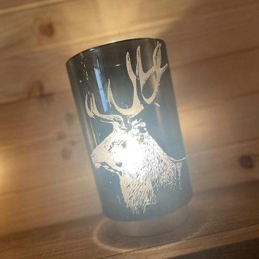 Lamp with a deer design on a wooden surface