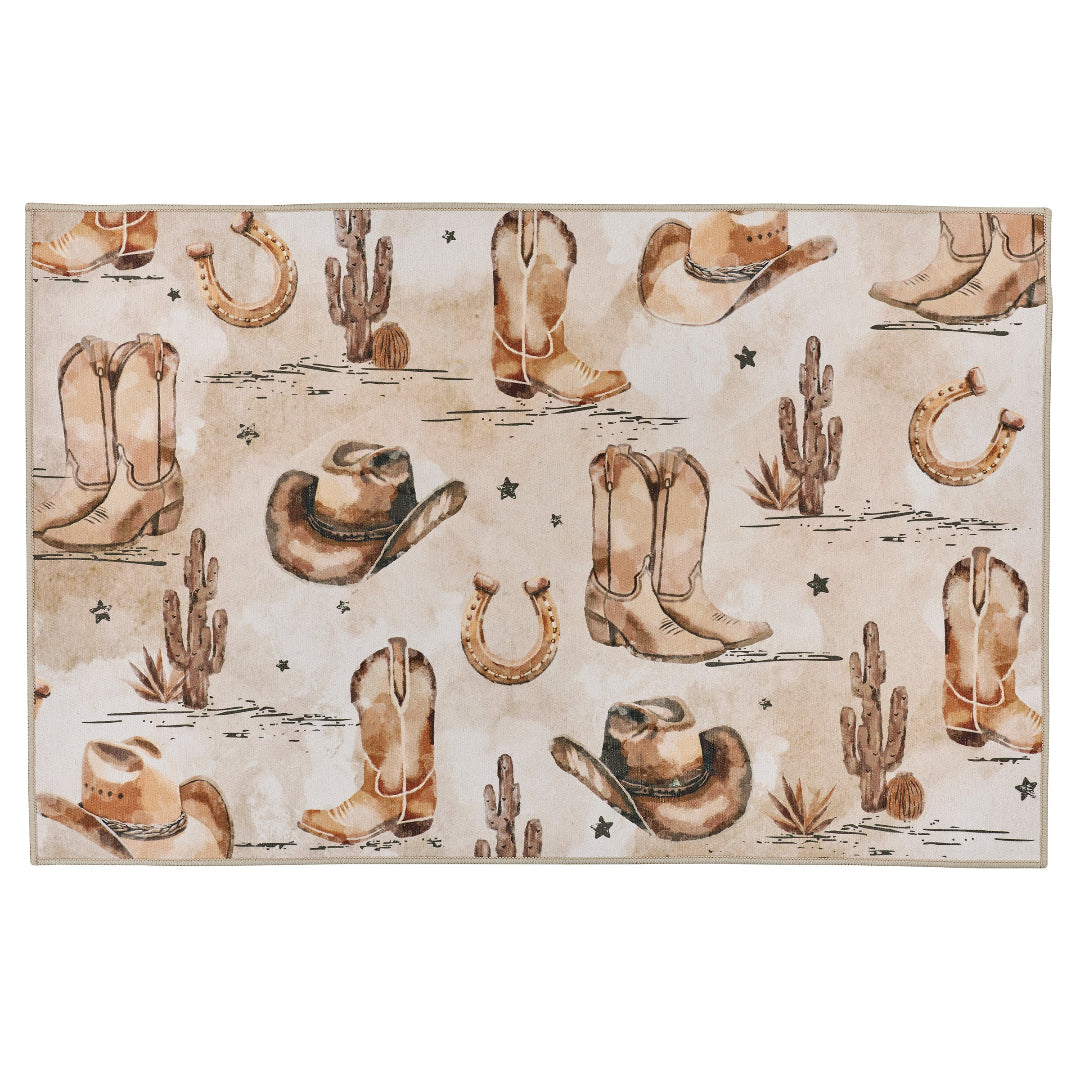 A rectangular area rug with a western desert theme, featuring watercolor-style illustrations of cowboy boots, hats, cacti, horseshoes, and stars on a light beige background.