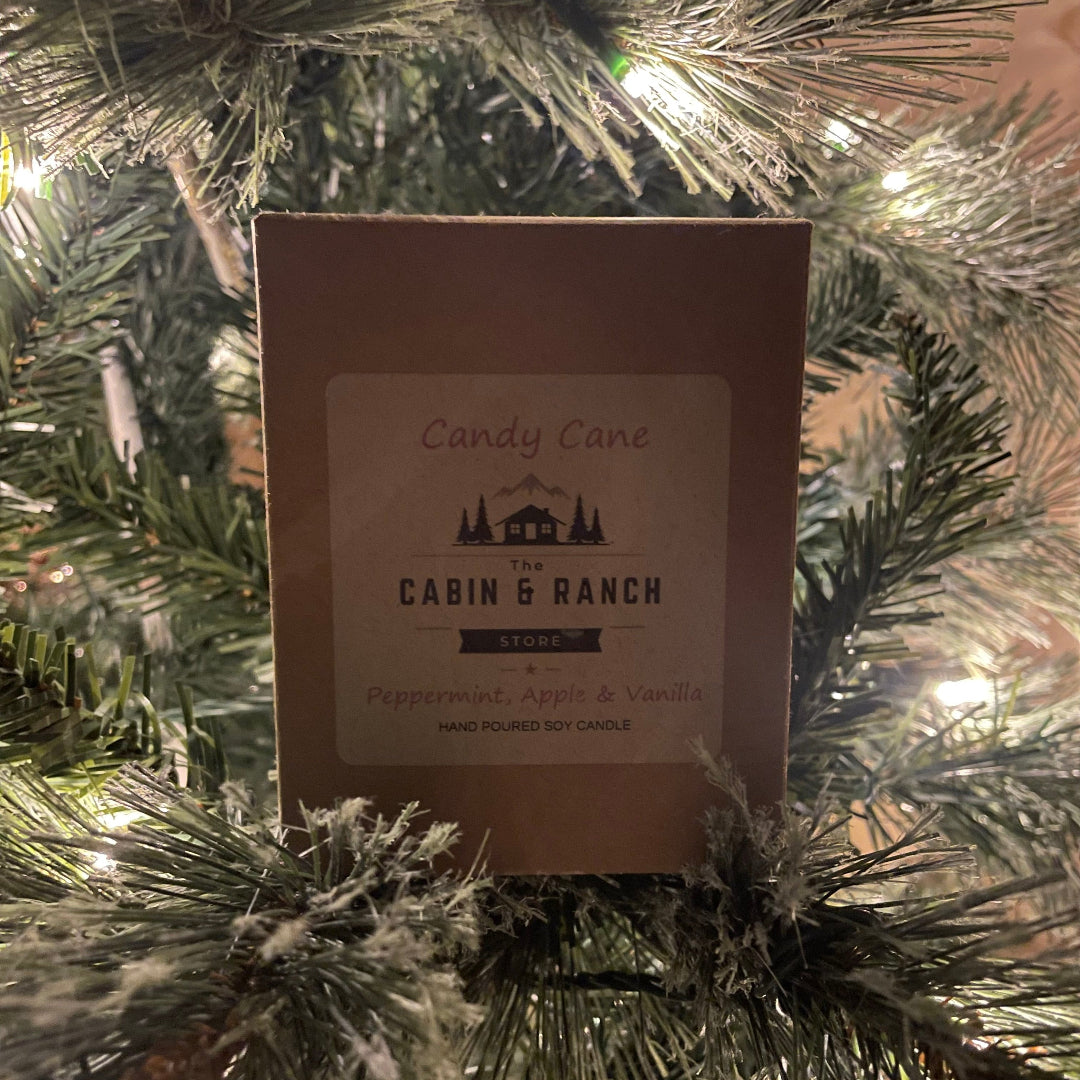 Candy Cane Christmas Candle from The Cabin & Ranch Store brand on a Christmas tree.