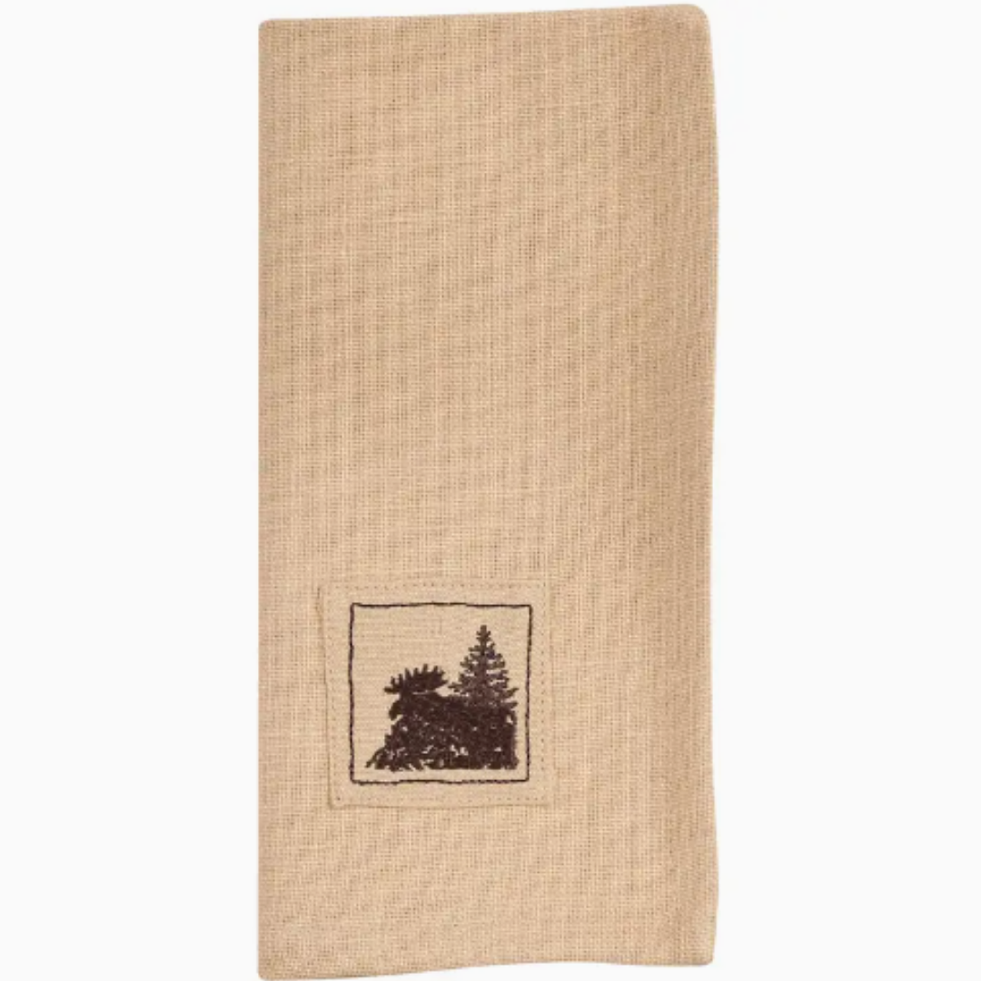 Beige napkin with embroidered design of trees with a moose