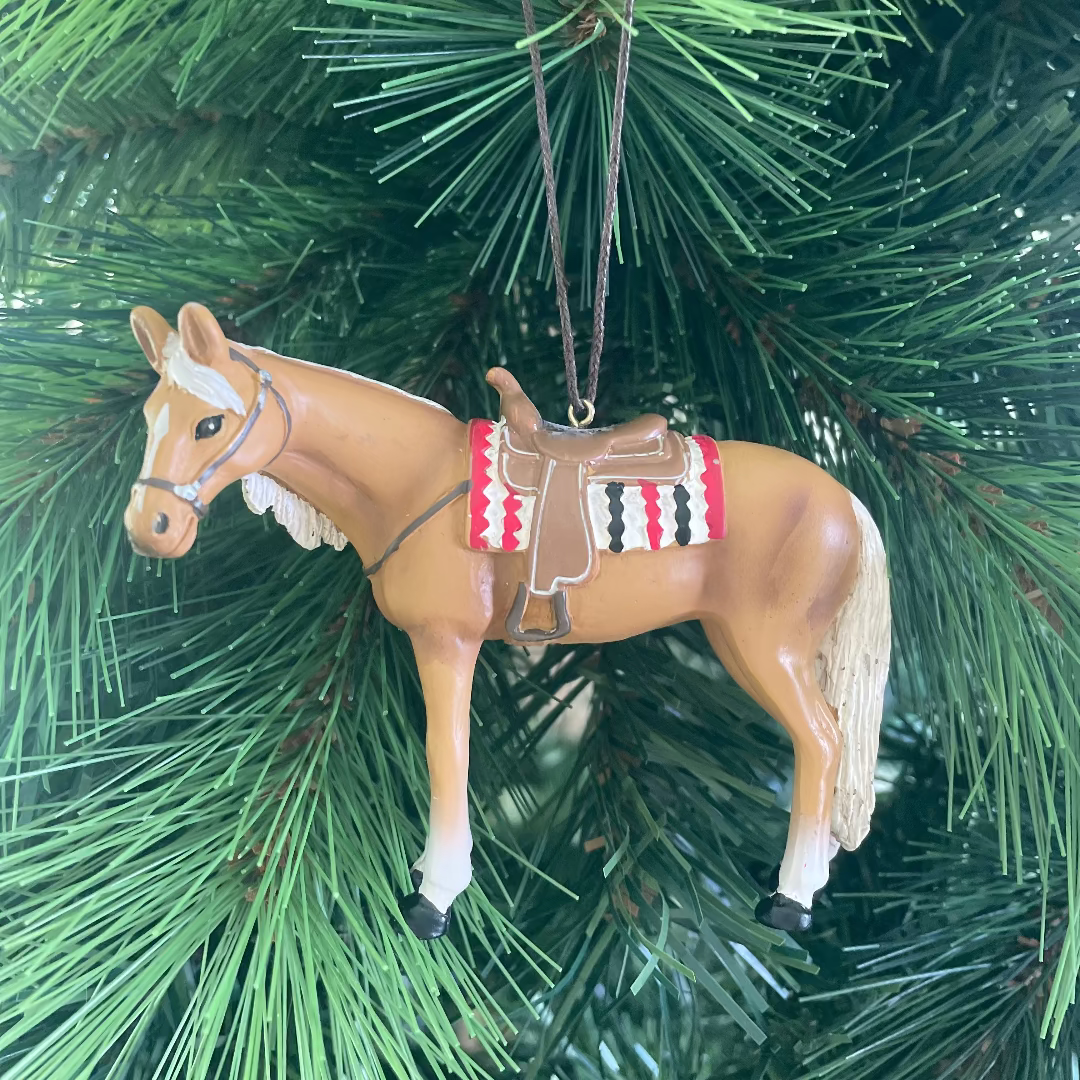 Horse ornament with a saddle on a Christmas tree