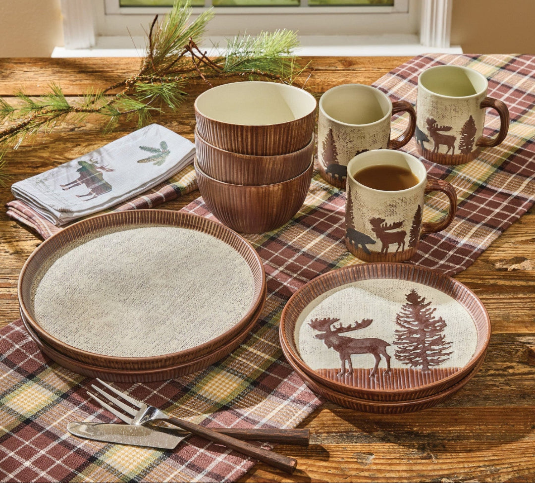 Lodge Ceramic dinnerware set with Wilderness themed design on a wooden table.