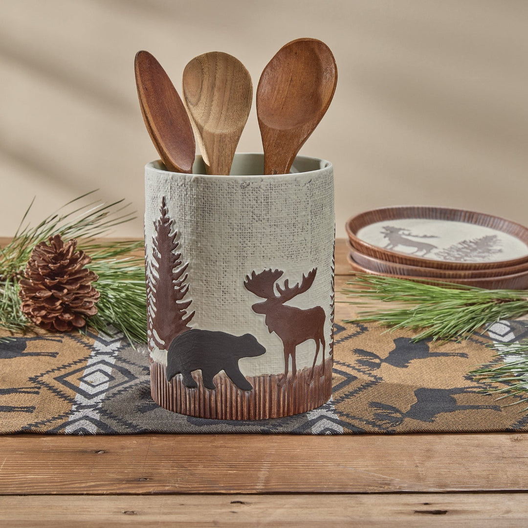 Wooden utensils in a Utensil Crock with nature-themed design on a wooden surface